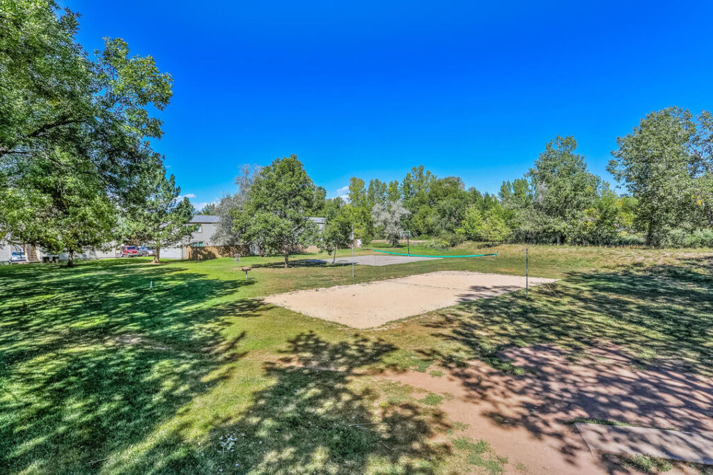 large field with basketball court and sand volleyball court