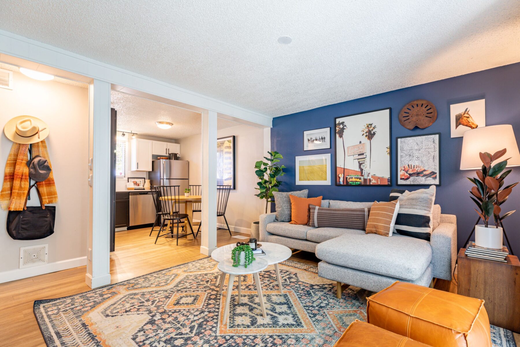 Living Room with blue accent wall and view of kitchen