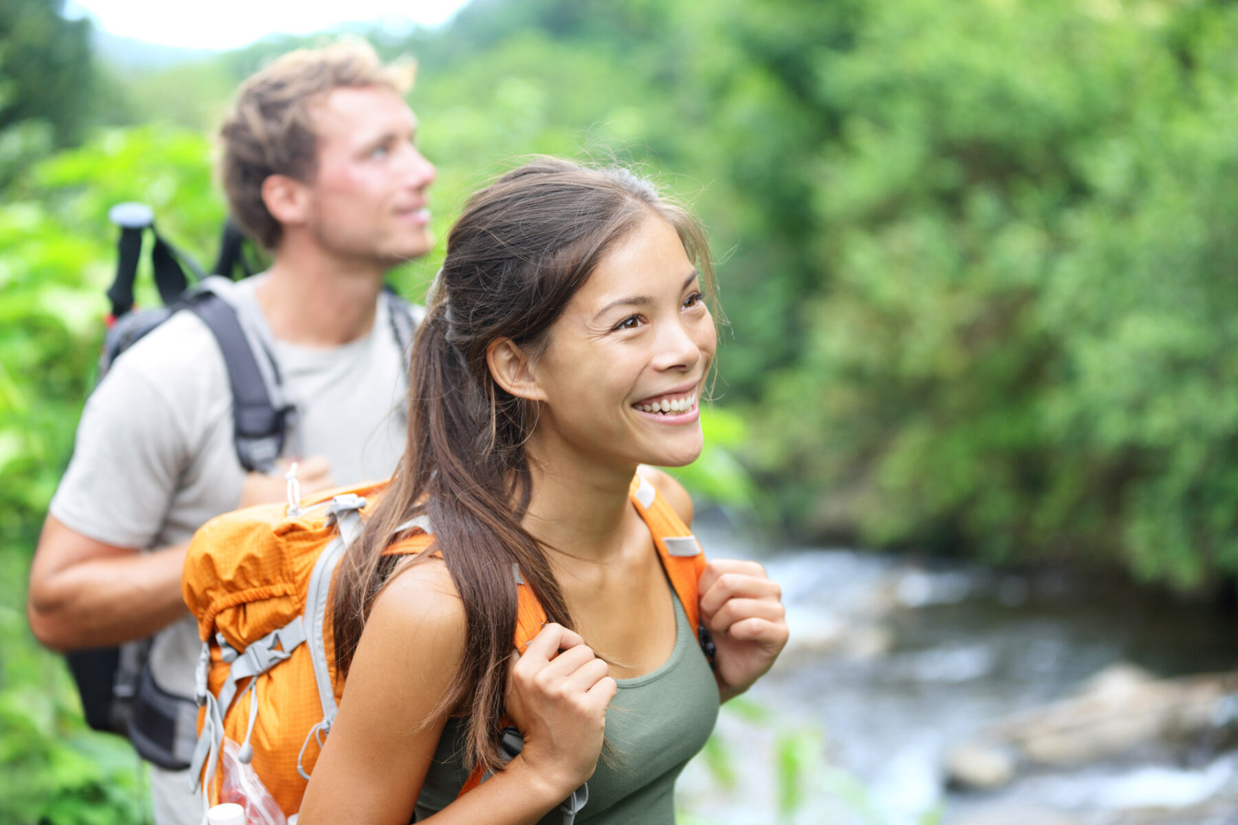 happy couple hiking in the woods