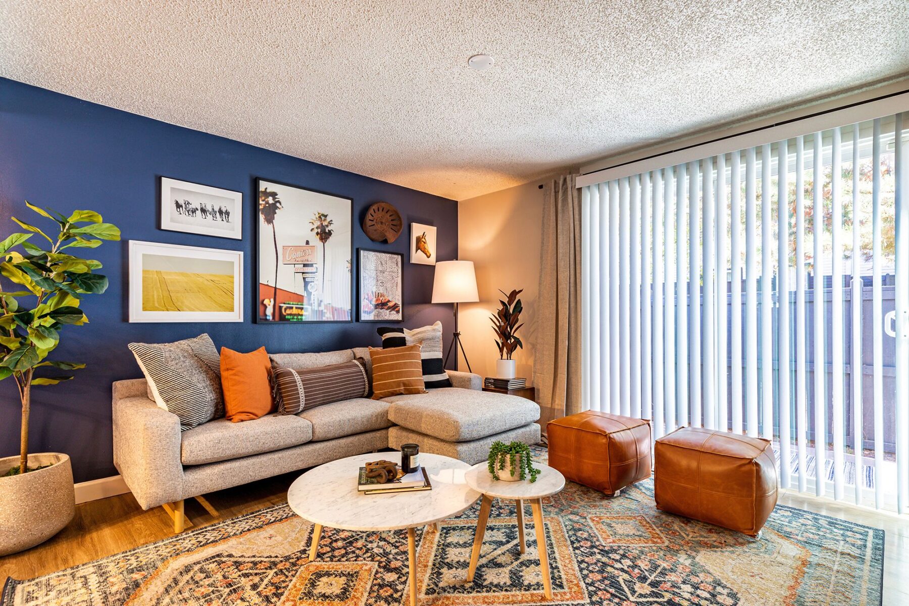 Living room with large windows and blue accent wall