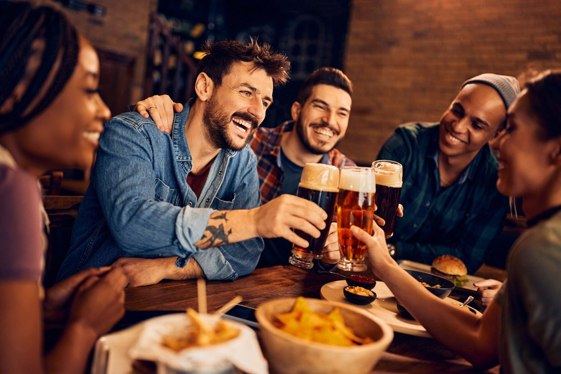 friends at a bar drinking beers