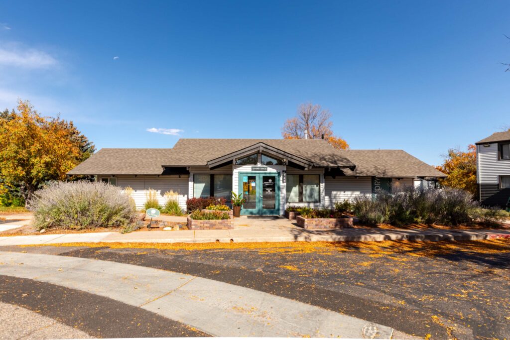 Leasing office exterior surrounded by landscaping