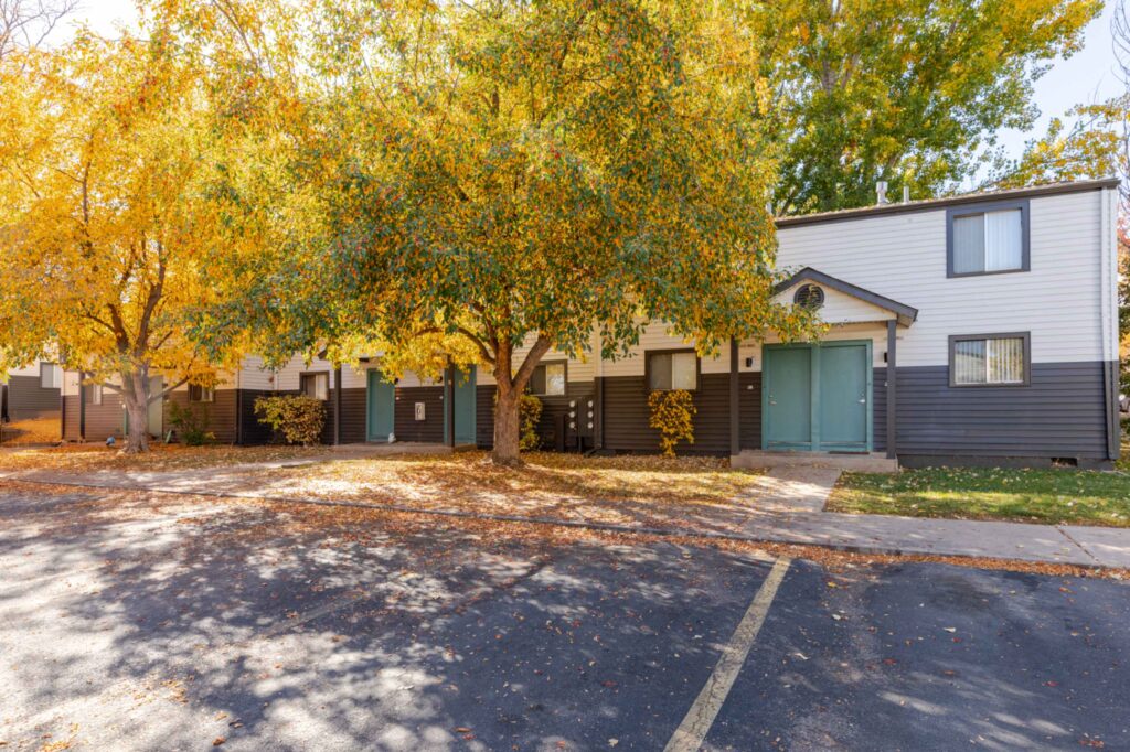 Building exterior with lots of large trees