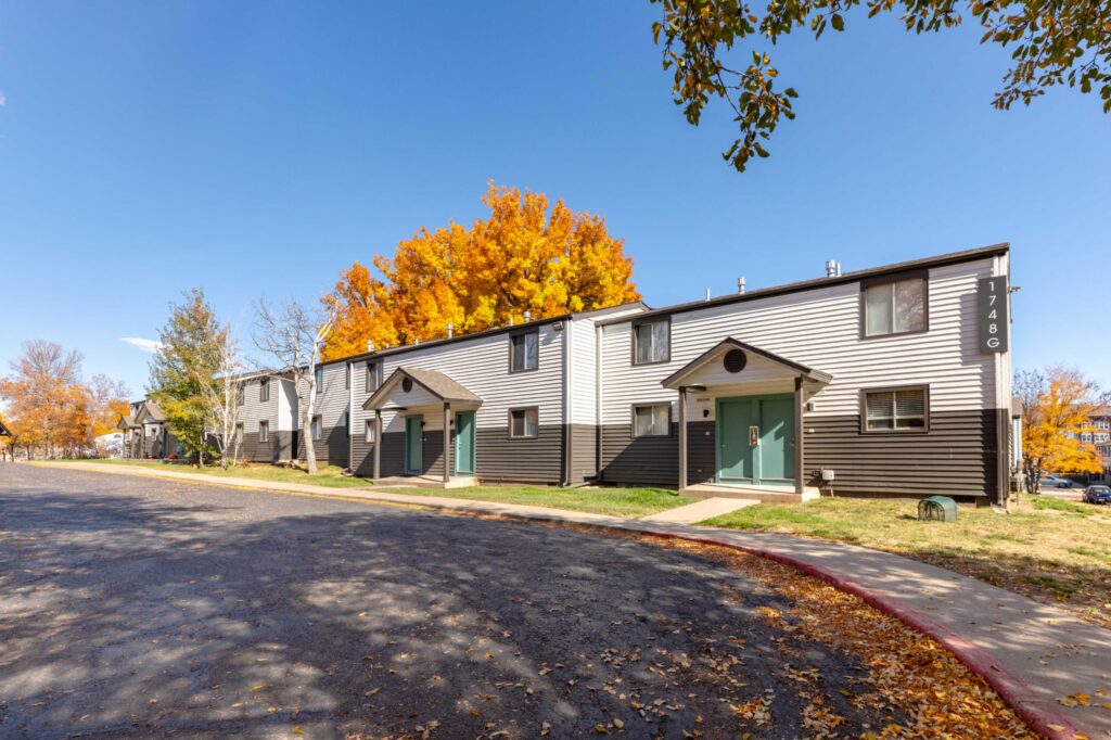 Building exterior with lots of large trees